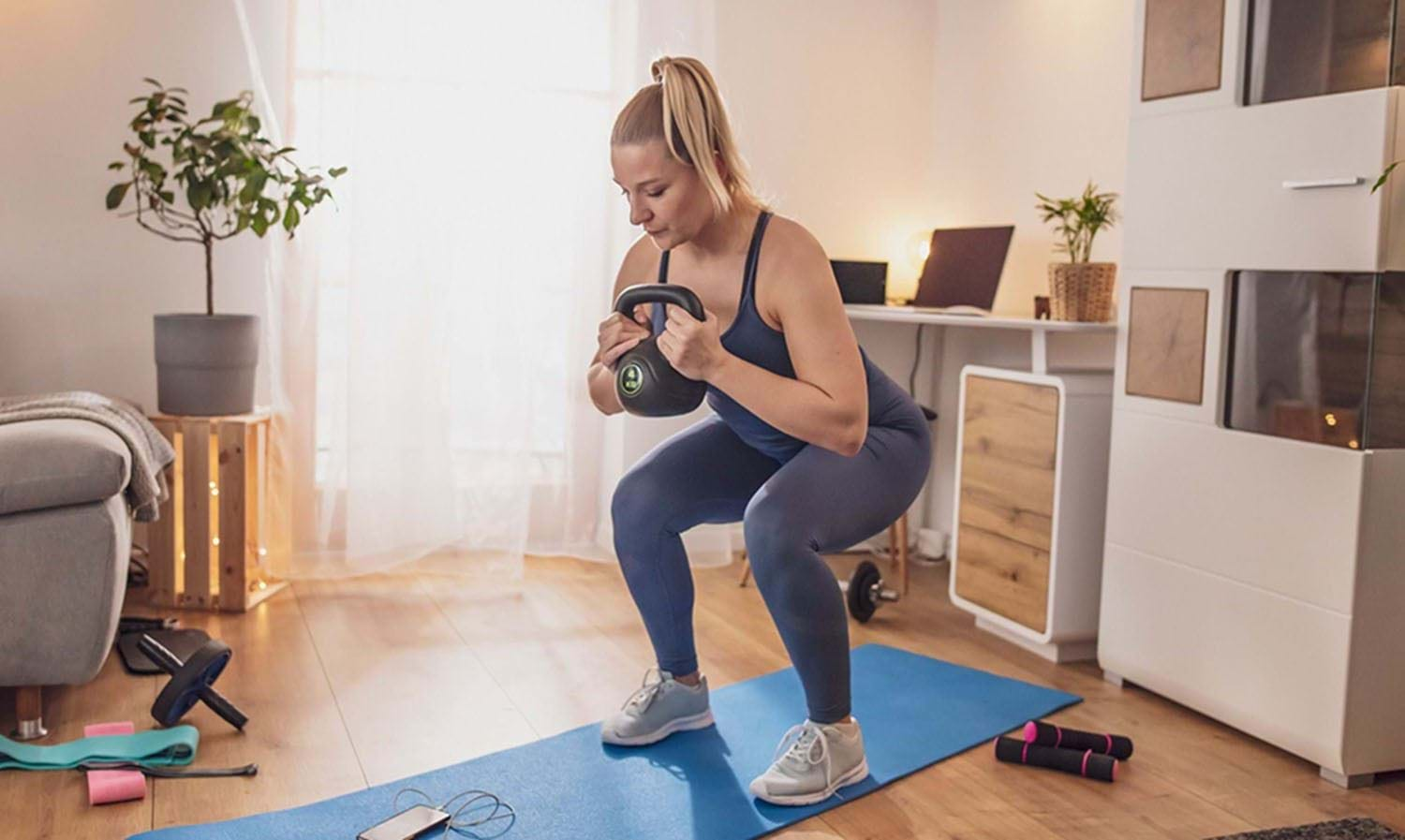 lady squatting with kettlebell