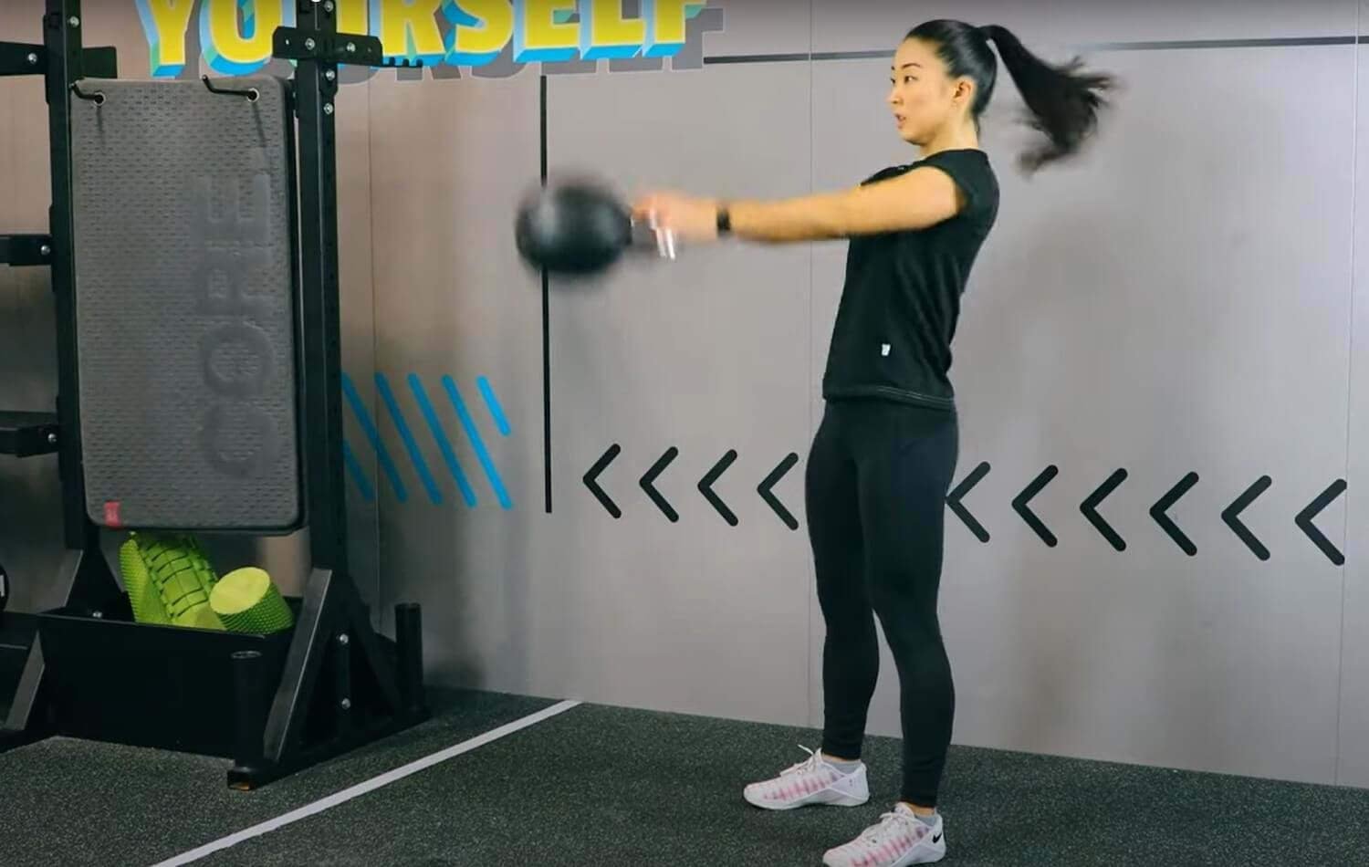 woman performing kettlebell swing